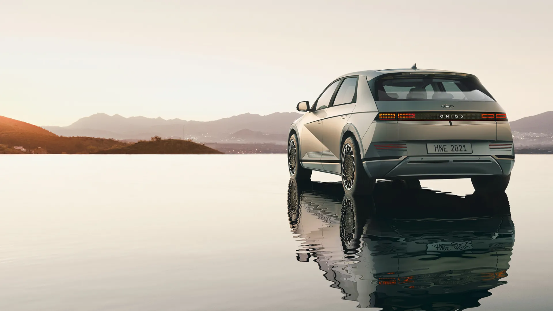 Hyundai SUV on salt lake plane during sunset