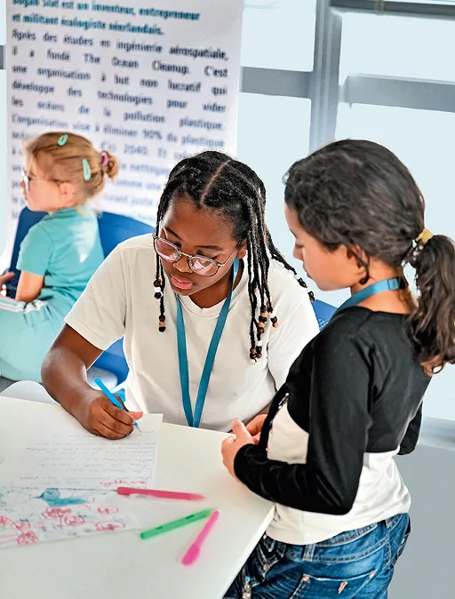Group of young girls smiling during a STEM workshop by Dassault Systèmes for the International Day of the Girl Child.