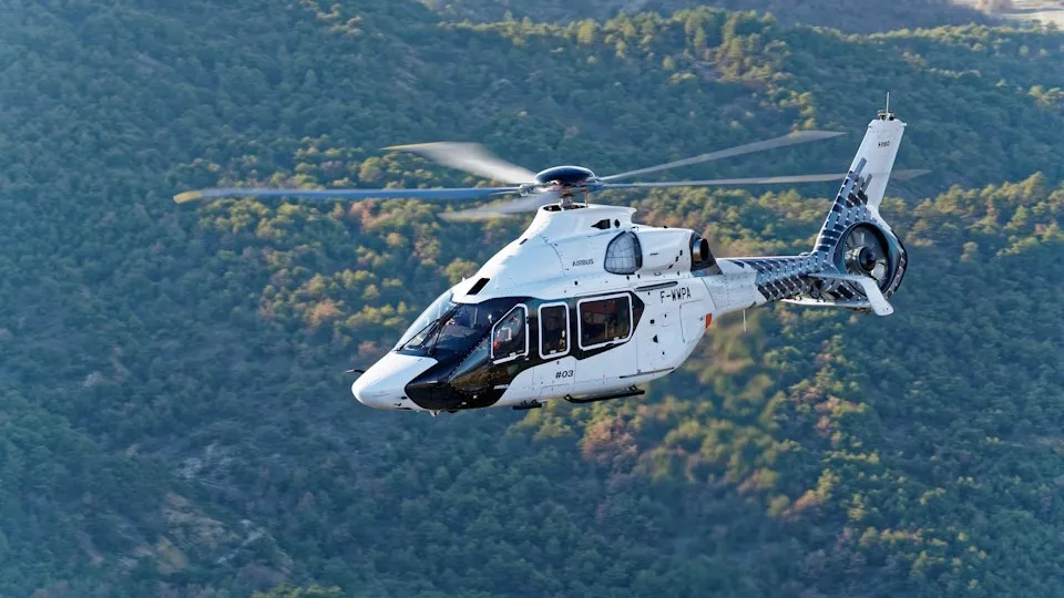Airbus H160 helicopter flying in clear sky, showcasing aerodynamic design and simulation-driven development.