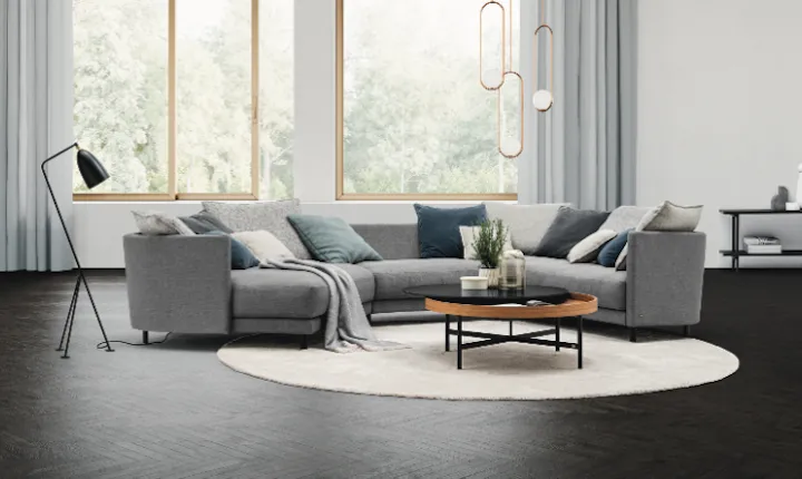 Rolf Benz gray sectional sofa with teal and white cushions in a modern Scandinavian-style living room.
