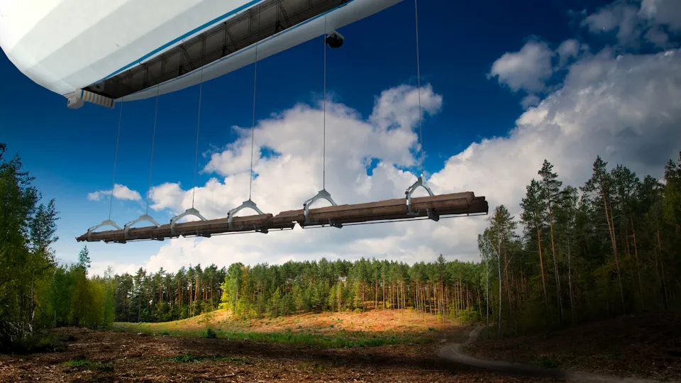 Flying Whales hybrid airship lifting timber logs over a forest using suspended clamp rigging for heavy cargo transport.
