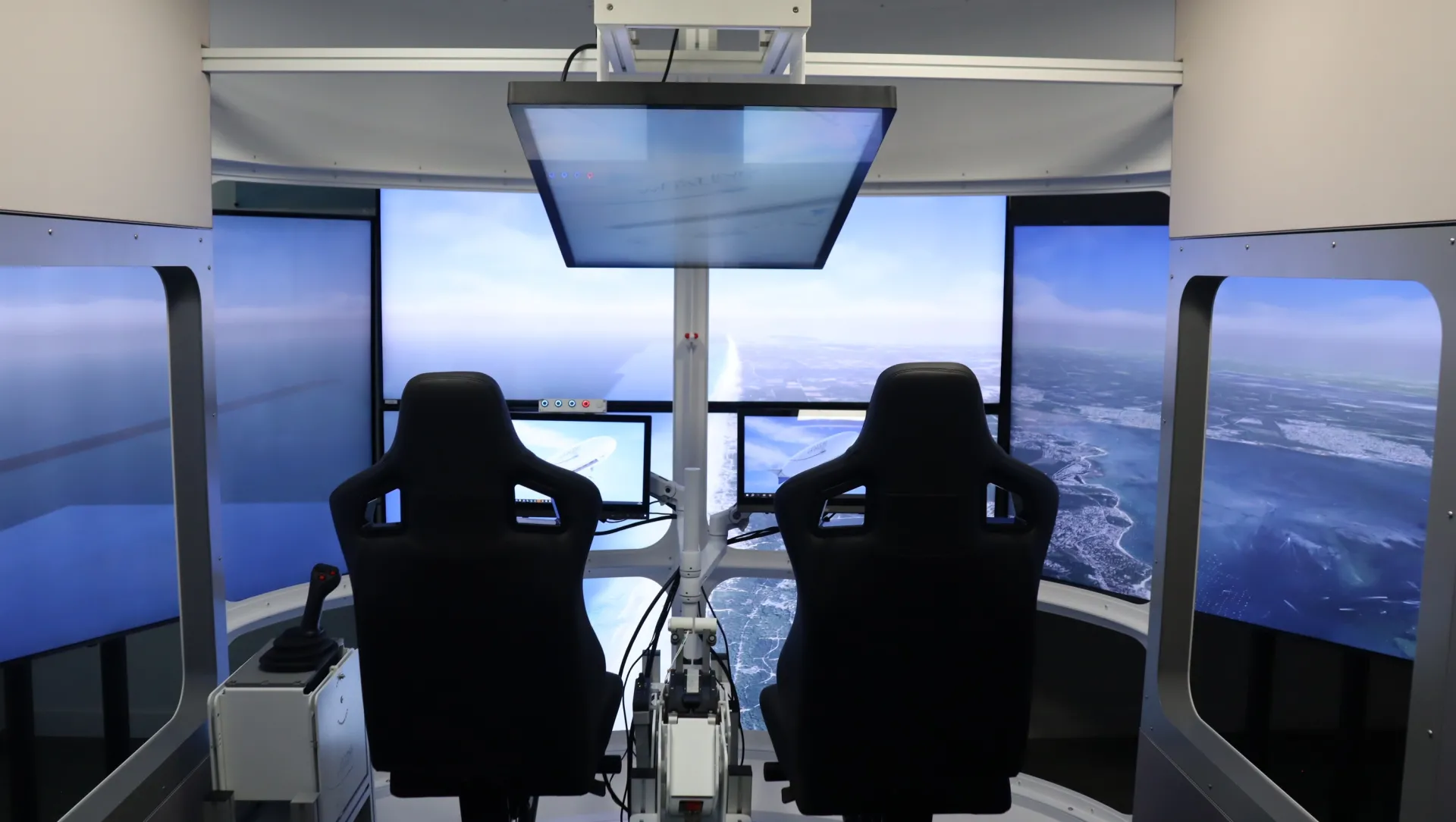 Flying Whales LCA60T hybrid airship cockpit interior showing pilot seats, control joystick, and instrument panels.