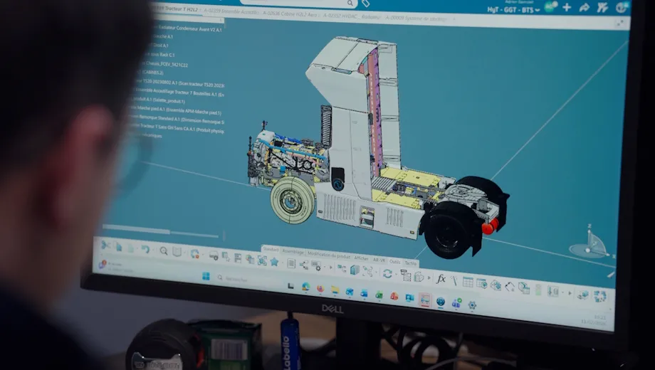 Engineer reviewing a 3D CAD model of a Hyliko hydrogen truck cab on the 3DEXPERIENCE platform using CATIA.