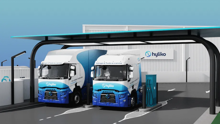Two Hyliko hydrogen fuel cell trucks refueling at a green hydrogen charging station.