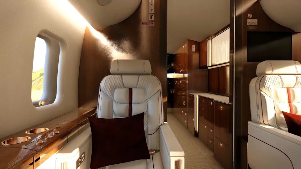 Luxury aircraft cabin interior designed by UUDS Aero featuring white leather seating, wood paneling, and ambient lighting.