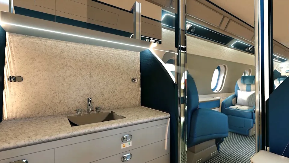 Luxury private jet cabin interior designed by UUDS Aero featuring a marble-finish lavatory sink and blue leather seating.