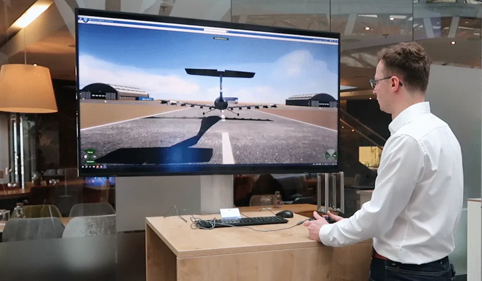 Engineer demonstrating Blue Spirit Aero Dragonfly aircraft simulation on a large display using 3DEXCITE visualization tools.