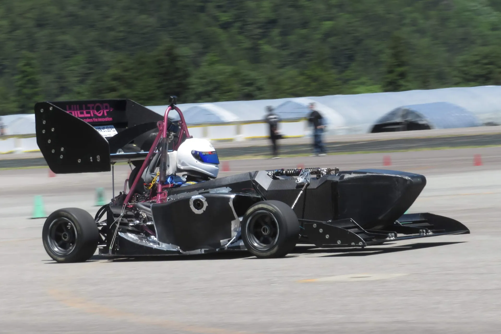 Grandelfino student team from Kyoto Institute of Technology posing with their Formula SAE race car in Japan