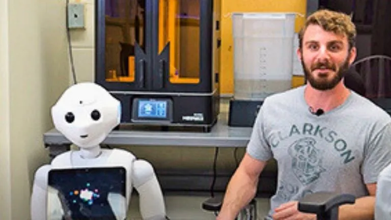 Students and researchers at Clarkson University's AIDFab lab using assistive device technologies for senior care innovation.