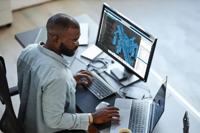 Manufacturing worker using AR headset with DELMIA software on 3DEXPERIENCE platform for connected operations