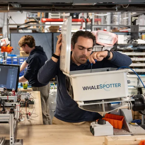 Entrepreneur at Greentown Labs using VR goggles at a workbench to develop sustainable climatetech hardware solutions