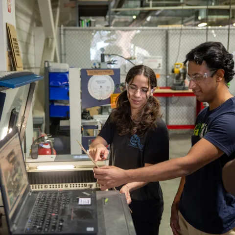 Two climatetech entrepreneurs collaborating at a workbench in the Greentown Labs incubator for hardware prototyping